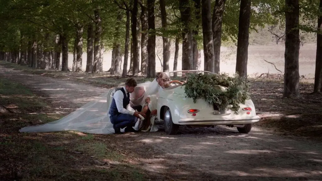 Trouwfilm Lunteren - Bruidegom houdt schoentje bruid vast